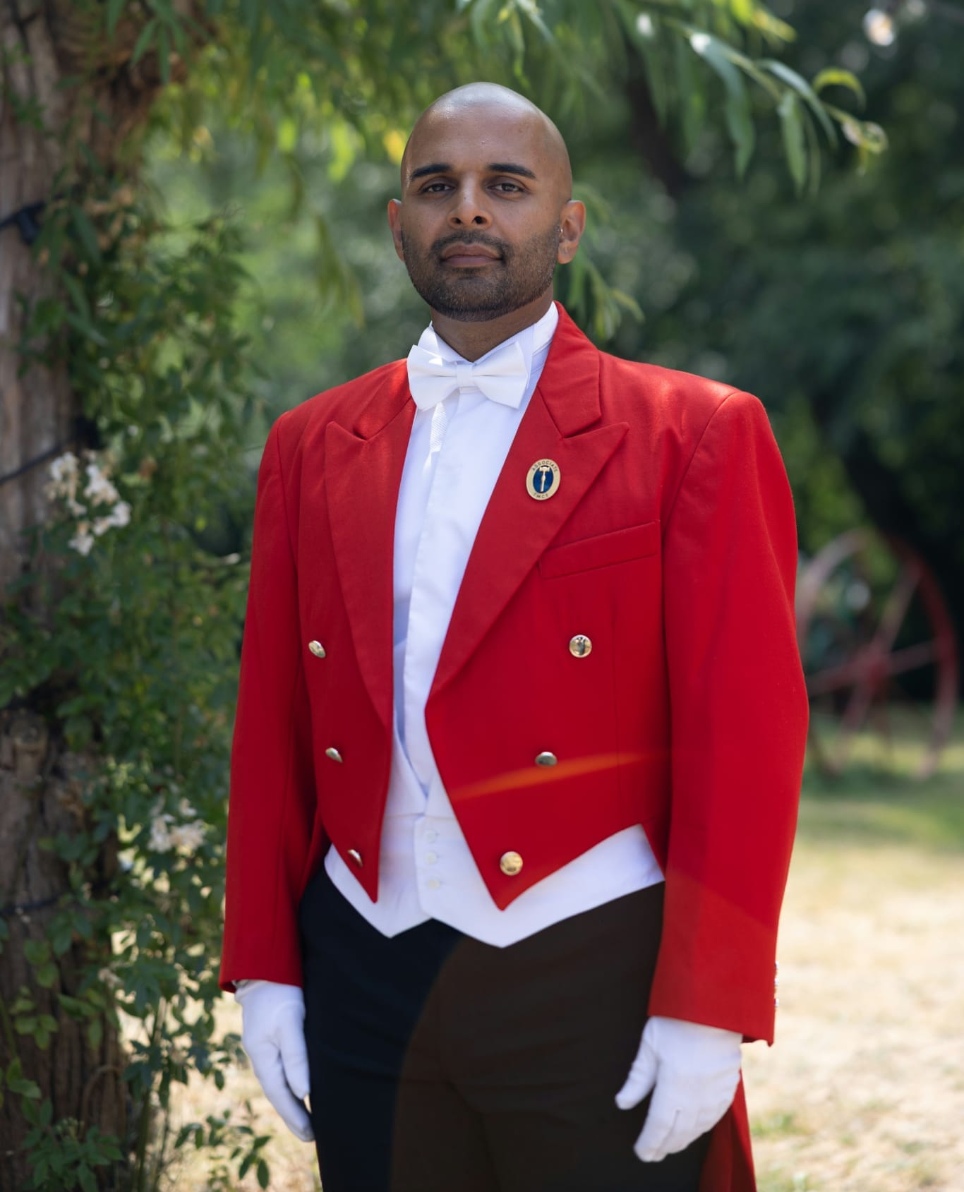 The Host Master UK in traditional red toastmaster attire